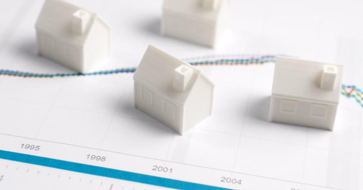 Model houses sitting on top of a graph