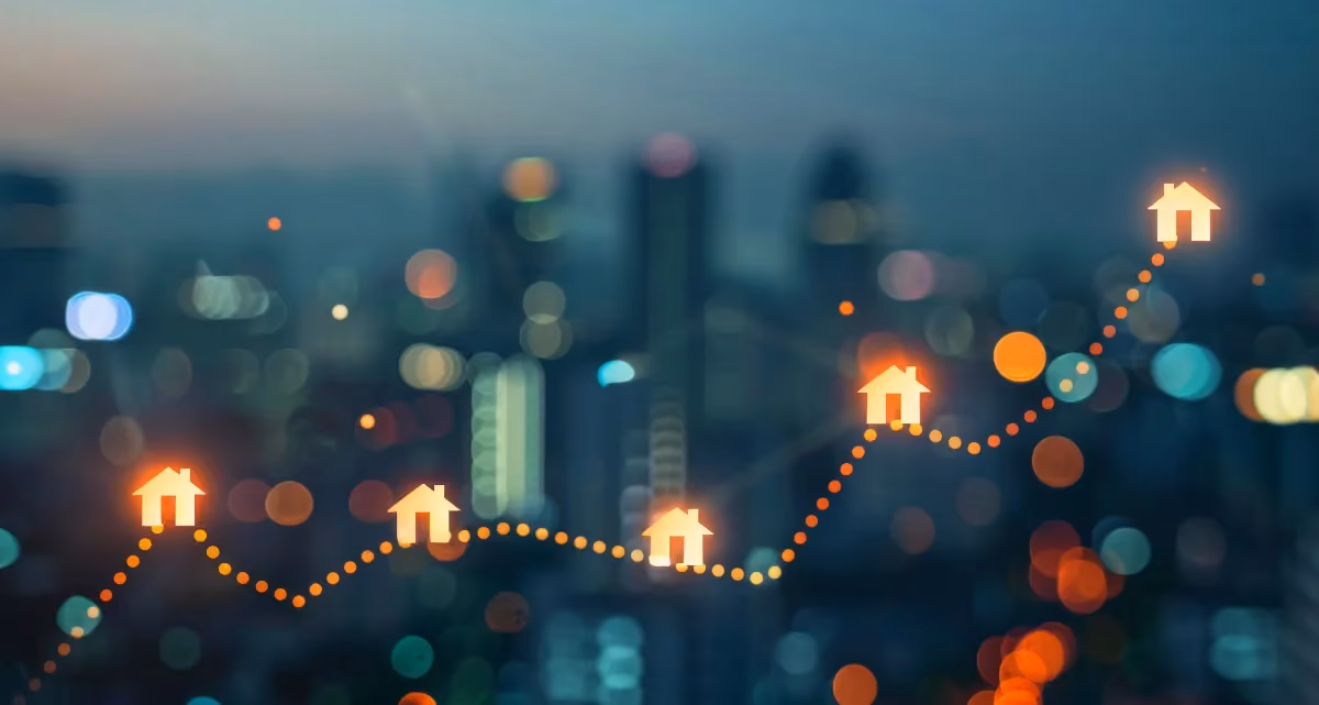 A graph line going up against a backdrop of a city skyline at night