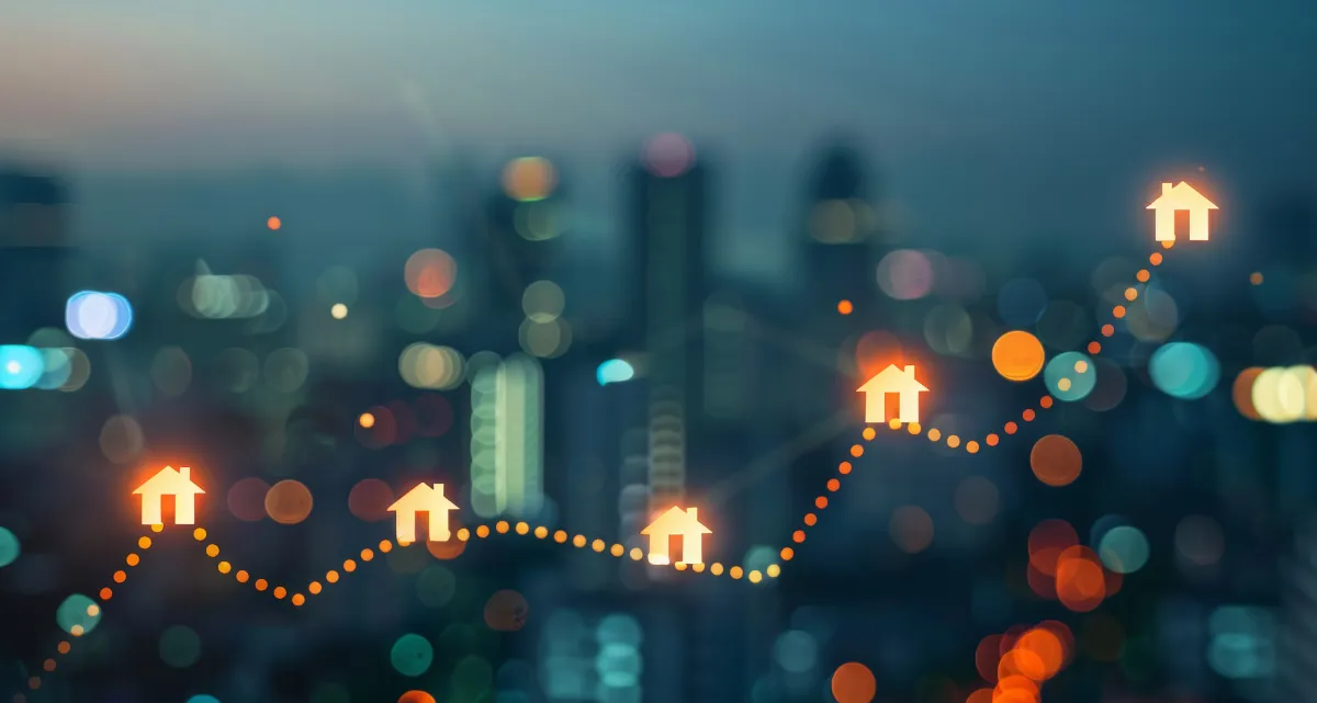 A graph line going up against a backdrop of a city skyline at night