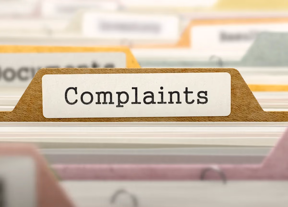 Folder labeled "complaints" in file cabinet