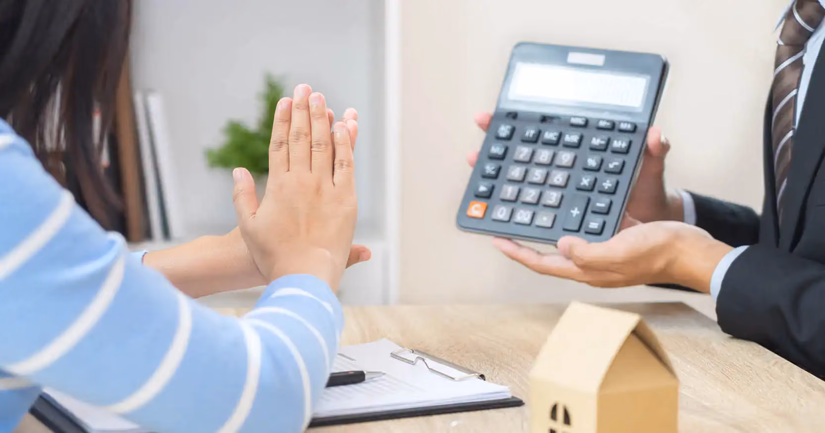 A person holding up a calculator