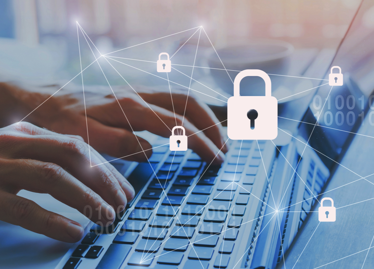 Padlock icons layered over man using a laptop