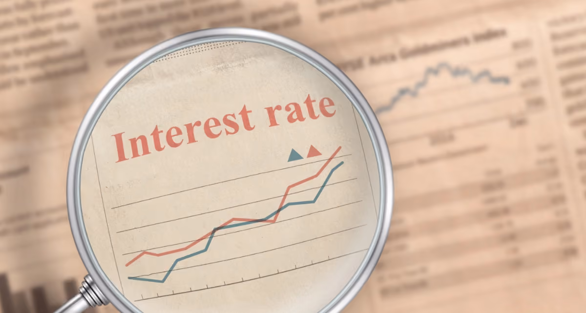 A magnifying glass magnifying "Interest rate" on a newspaper