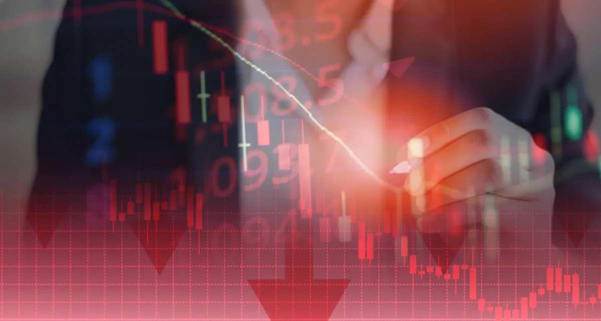A man in a suit behind a transparent red screen of graphs with a falling trend line
