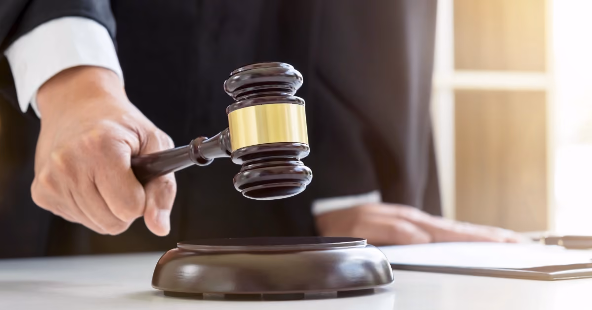 A person striking a gavel