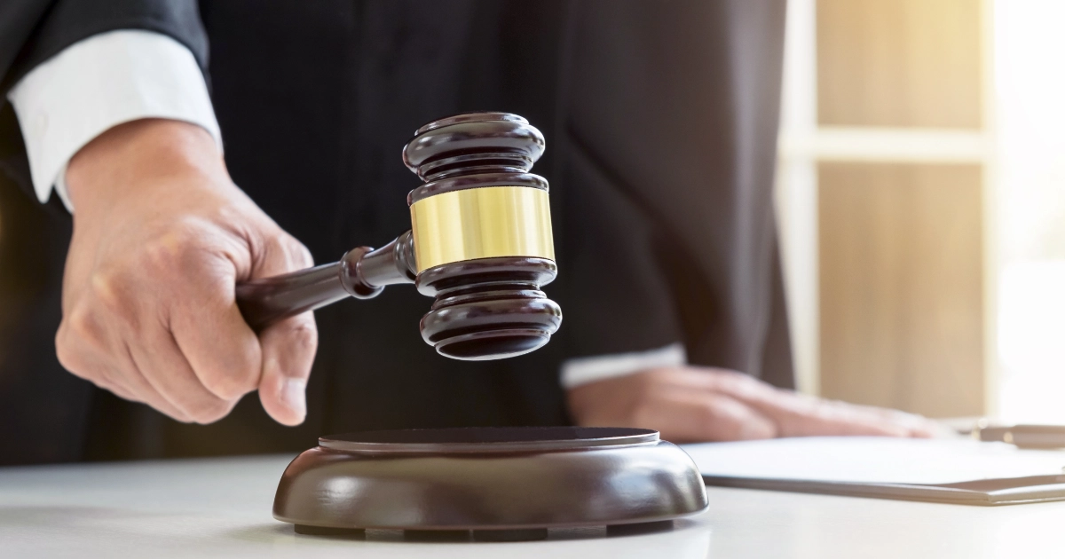 A person striking a gavel