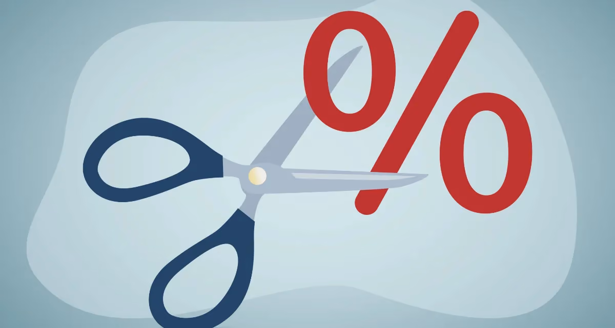 A pair of scissors cutting a percentage sign