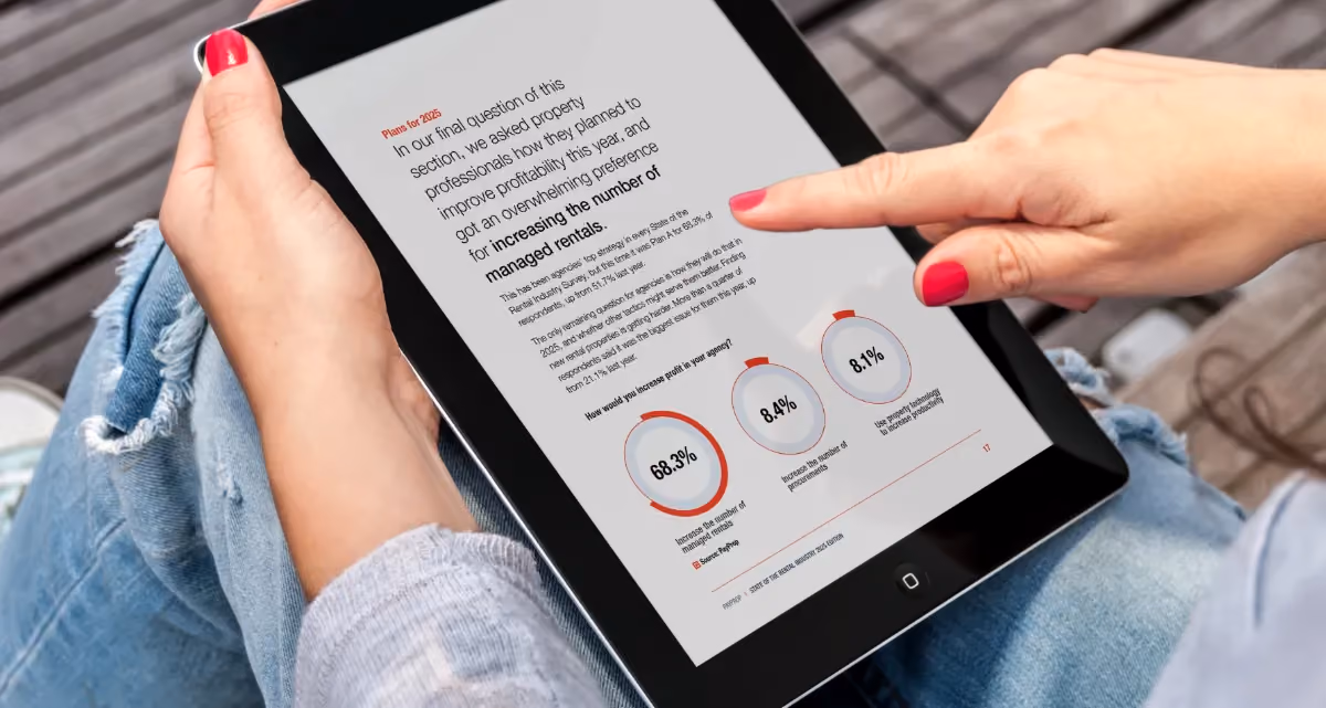 A person looking at a page from the State of the Rental Industry survey on a tablet