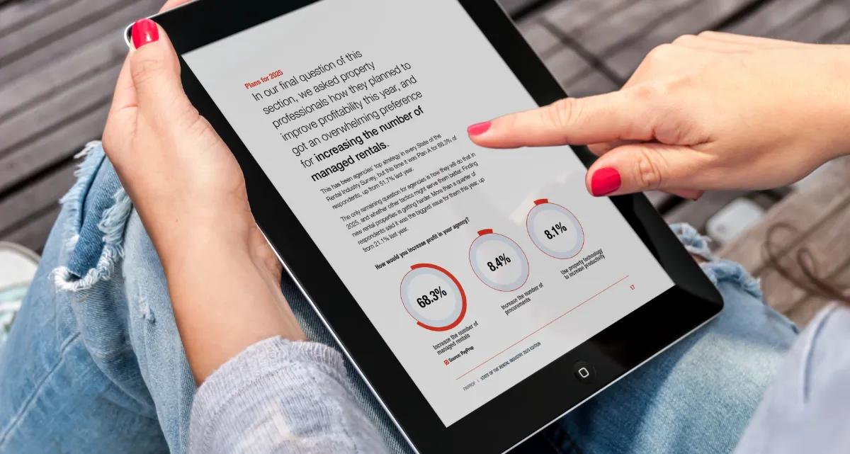 A person looking at a page from the State of the Rental Industry survey on a tablet