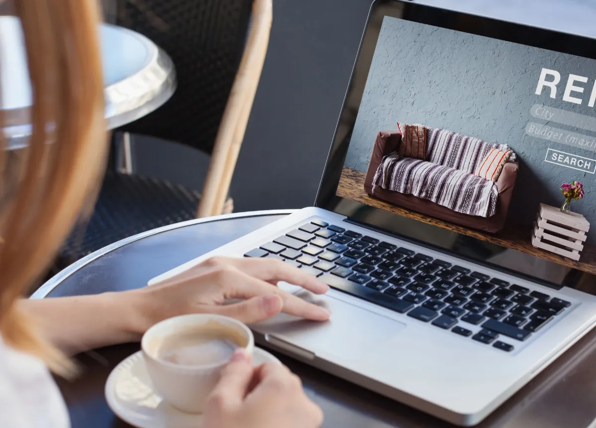 Woman researching rental listings on laptop