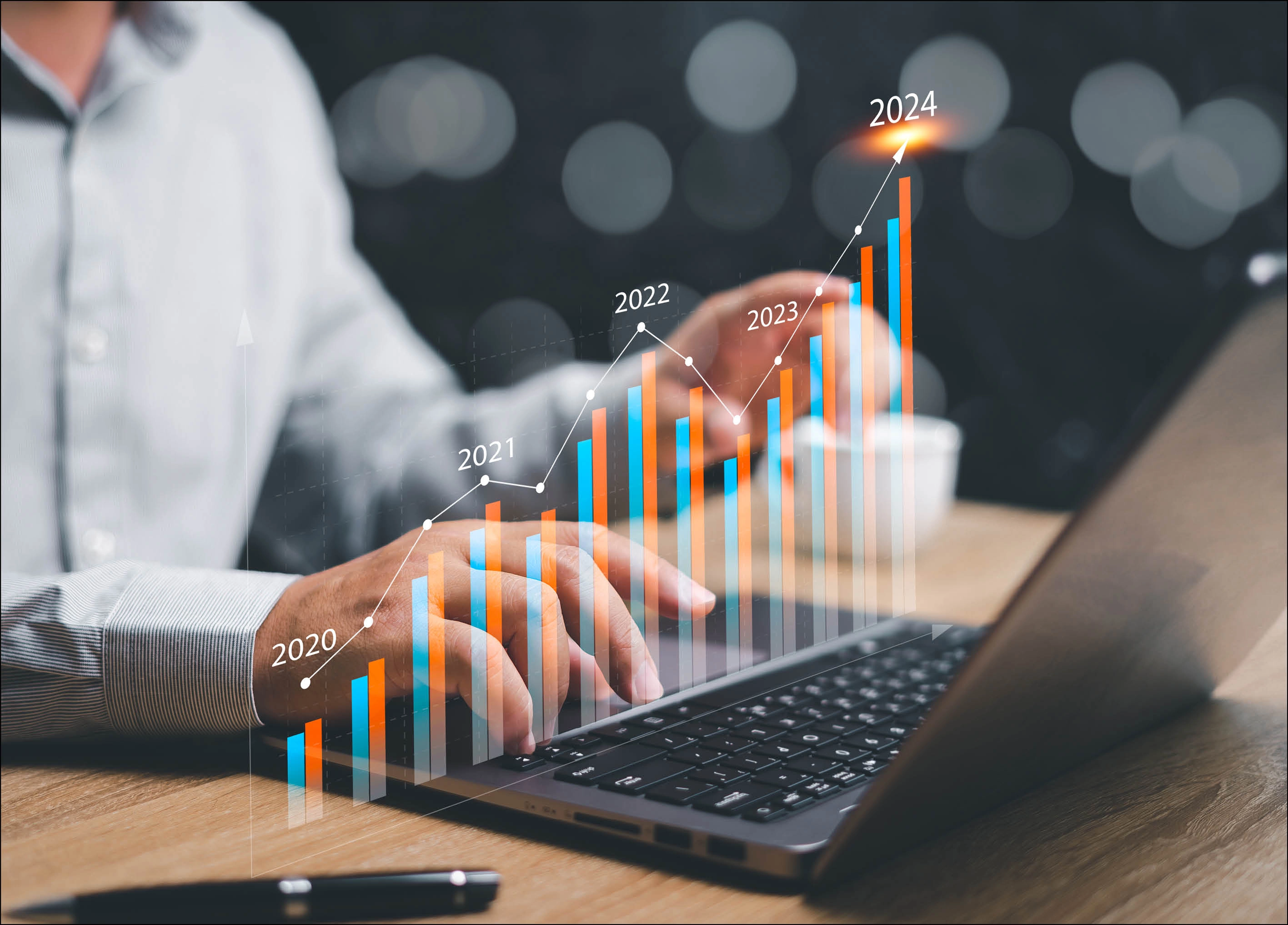 Businessman using laptop calculating exponential business growth in 2024