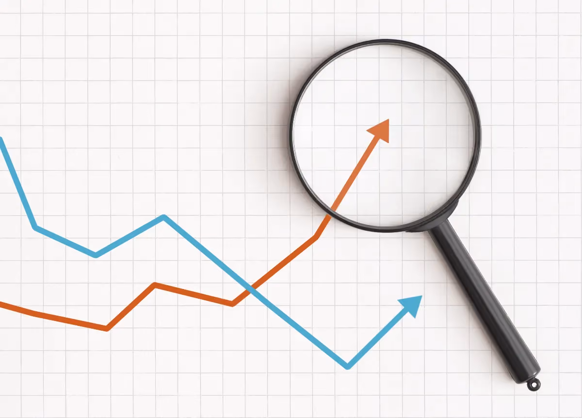 Two line graphs under a magnifying glass