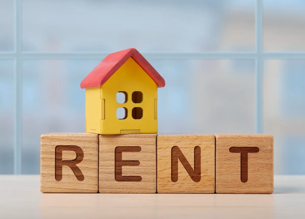 Wooden blocks that spell "rent"