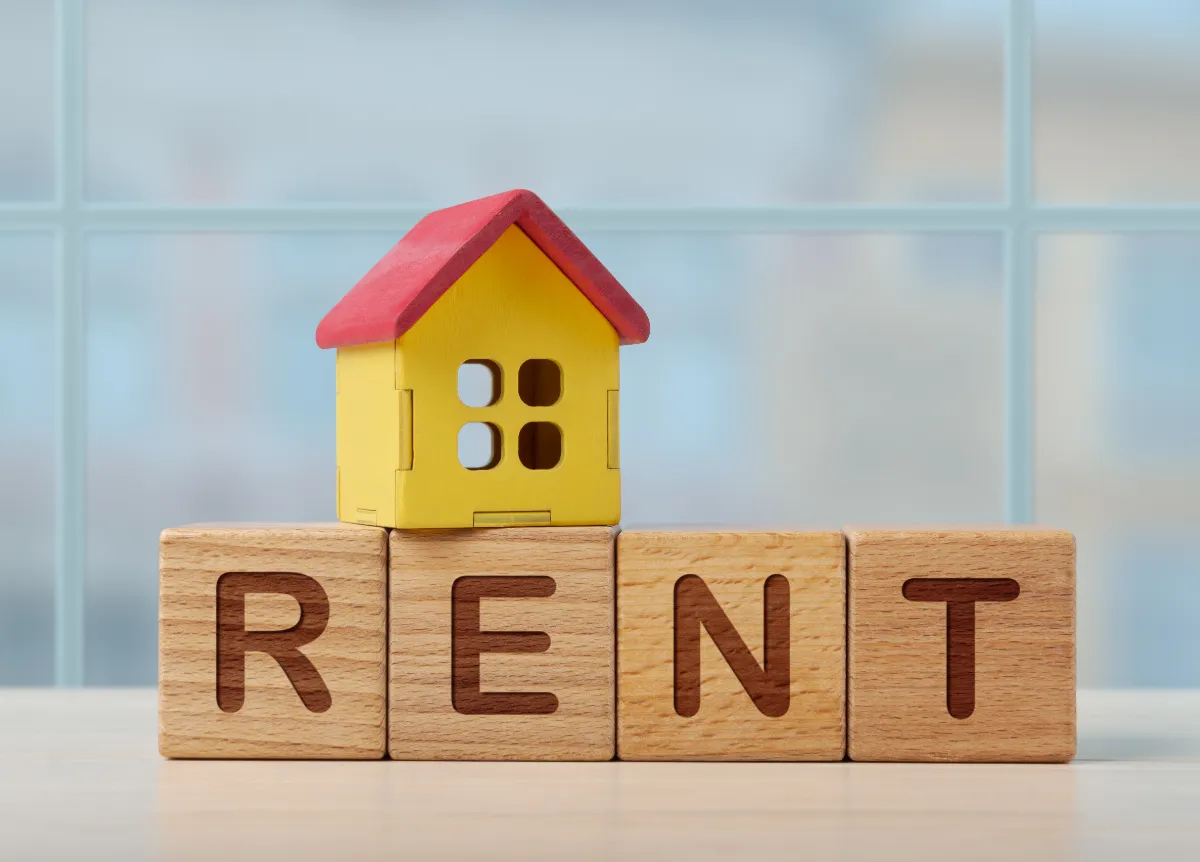 Wooden blocks that spell "rent"
