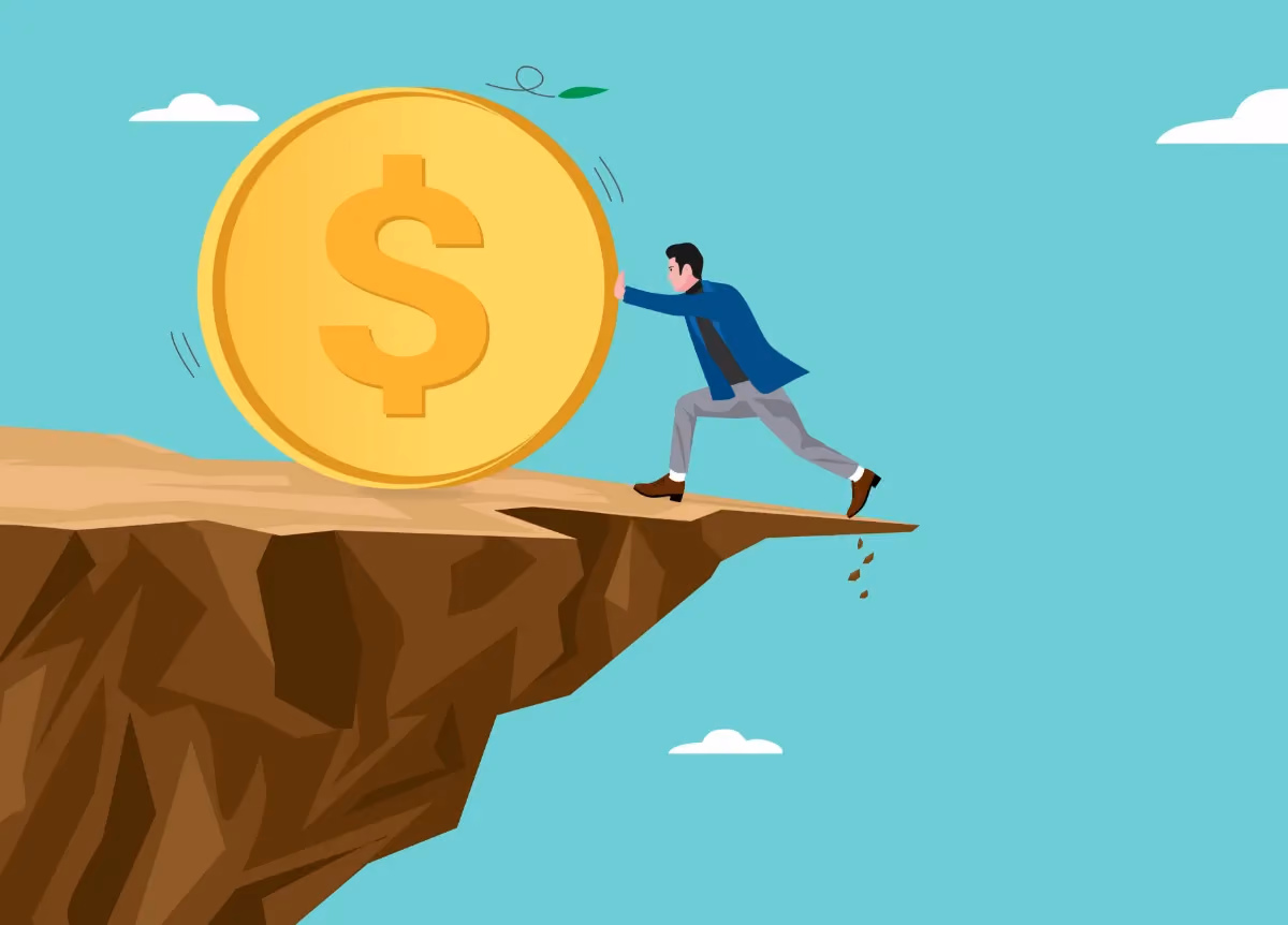 Man pushes giant coin away from cliff