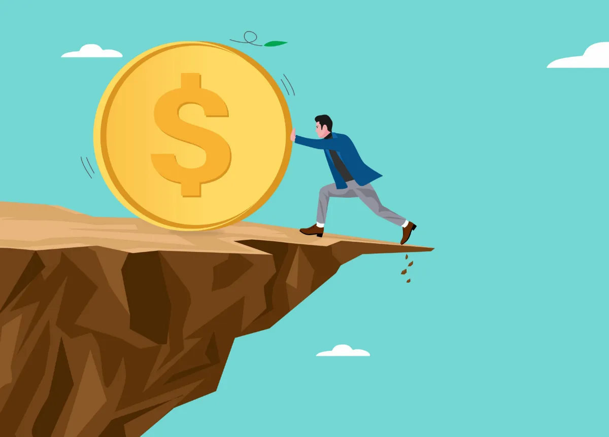 Man pushes giant coin away from cliff