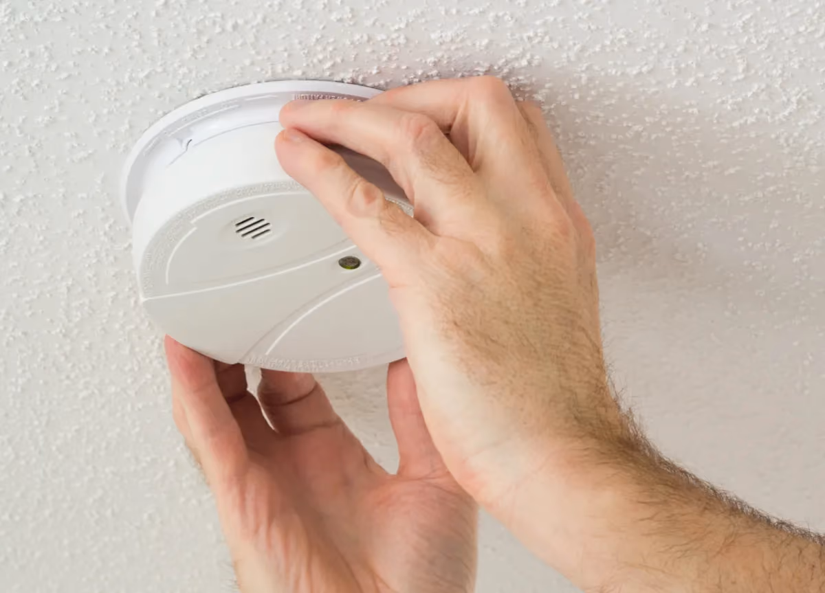 Man installing a smoke alarm.