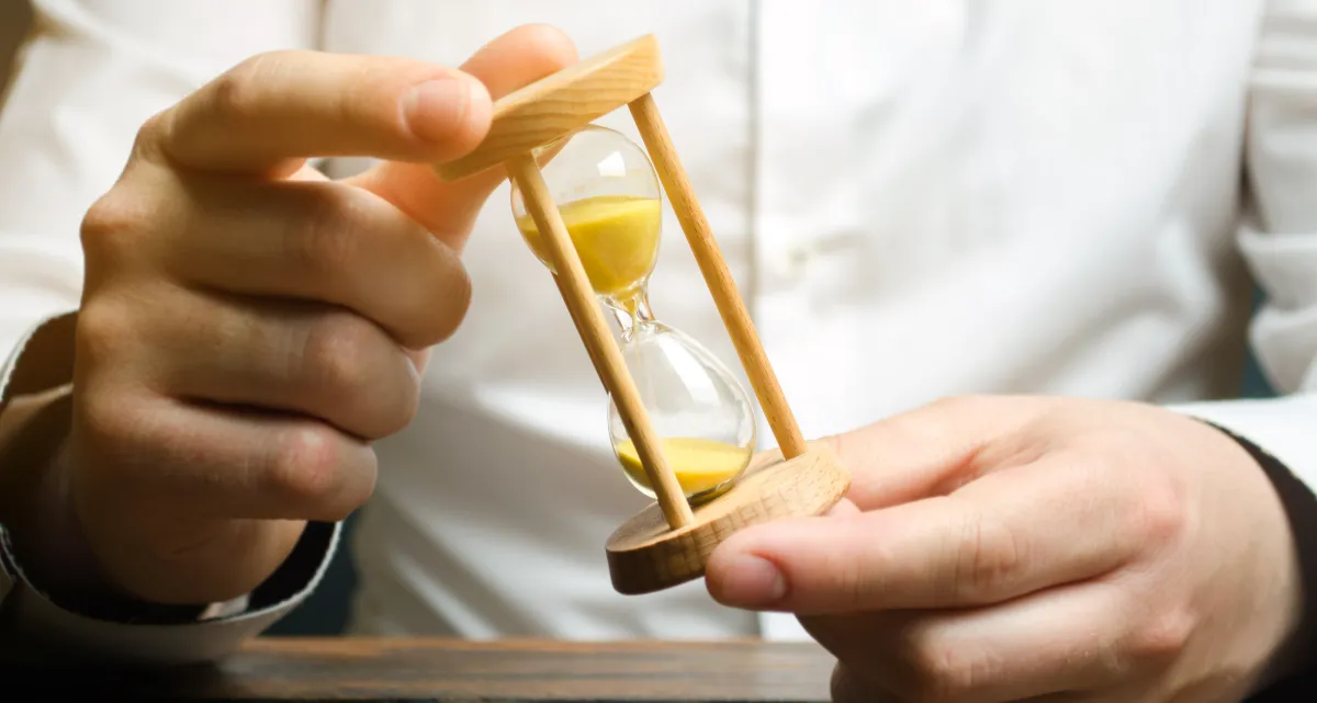 A man holding an hourglass