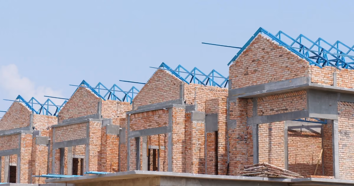 A row of houses under construction with the roofs missing