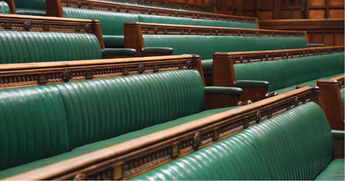 Empty green benches in the House of Commons