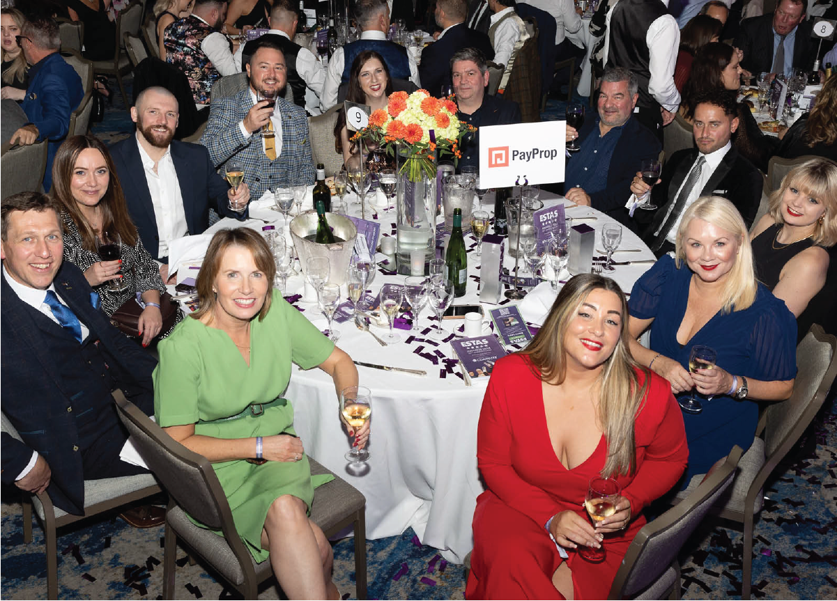 A group of PayProp employees seated at a table at the ESTAS Awards