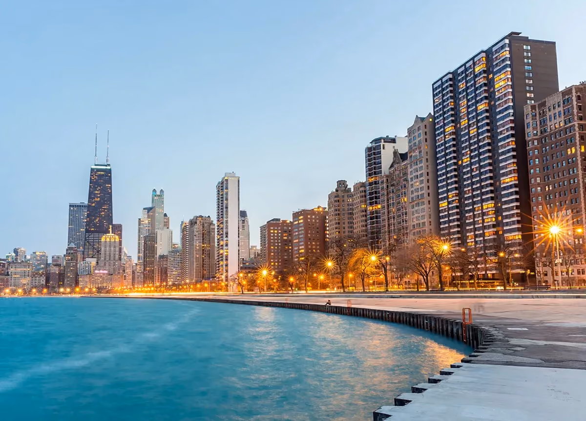 A cityscape picture of the Chicago skyline with a waterfront in the foreground