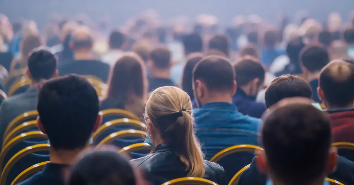 The backs of heads at a conference
