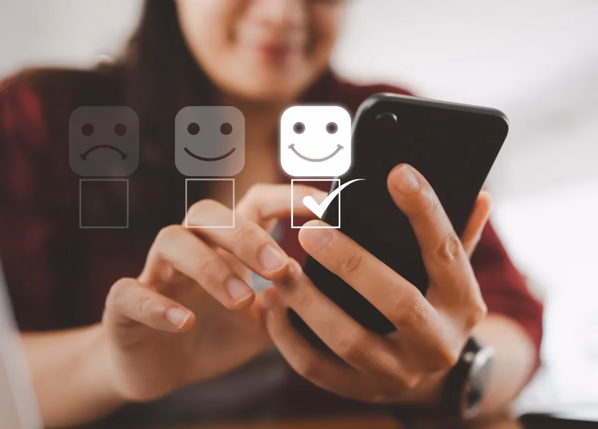Woman ticks box with happy face on satisfaction survey