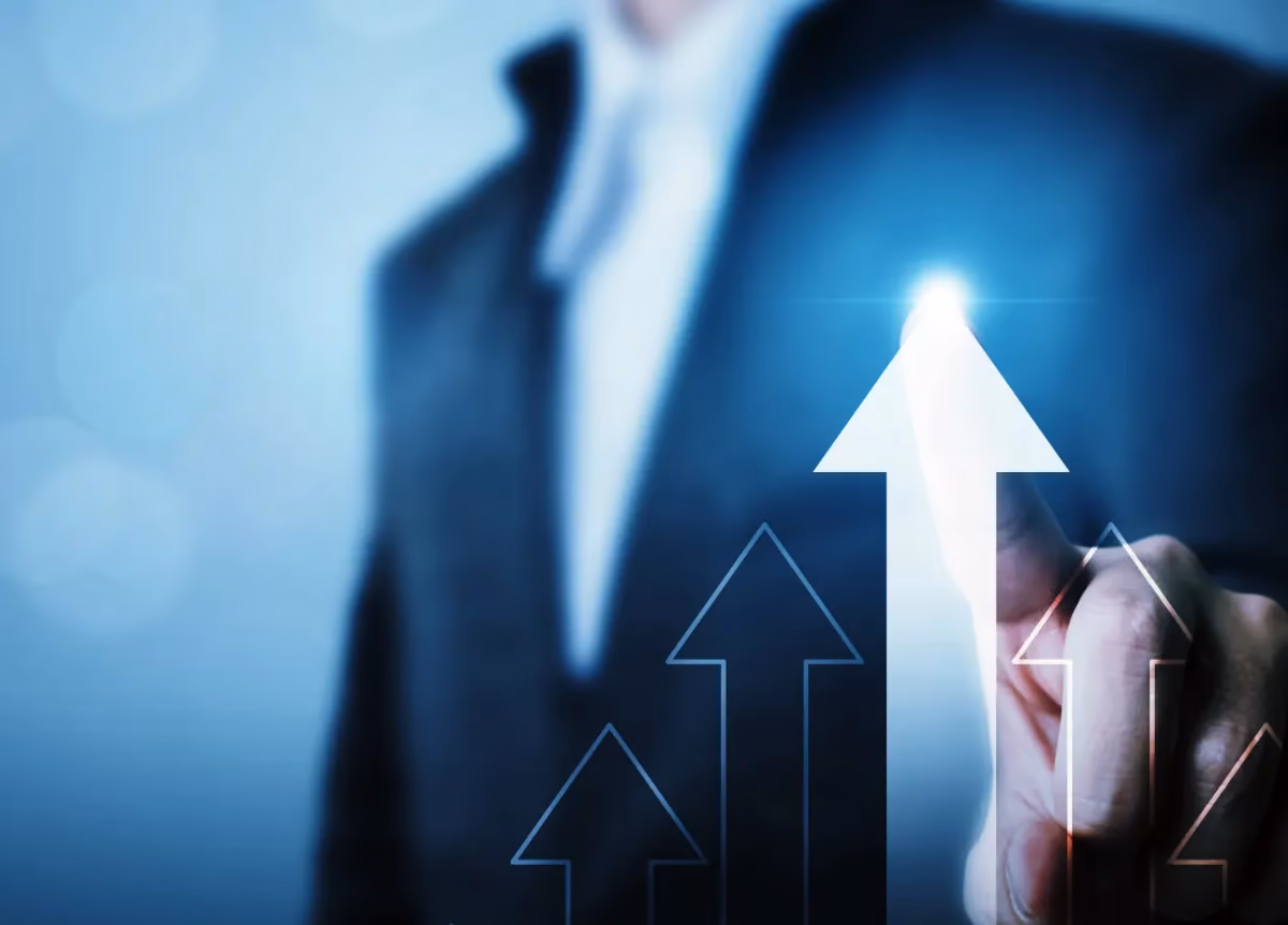 Businessman tracing five arrows pointing up
