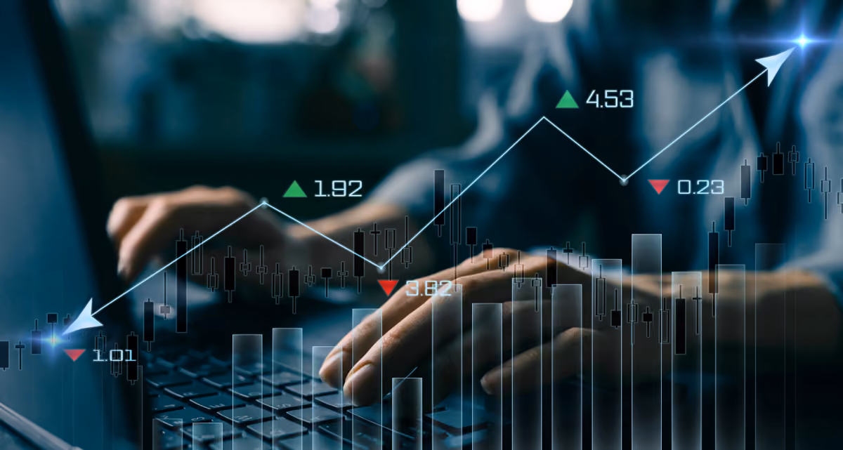 A pair of hands using a laptop with a graph line superimposed over the image