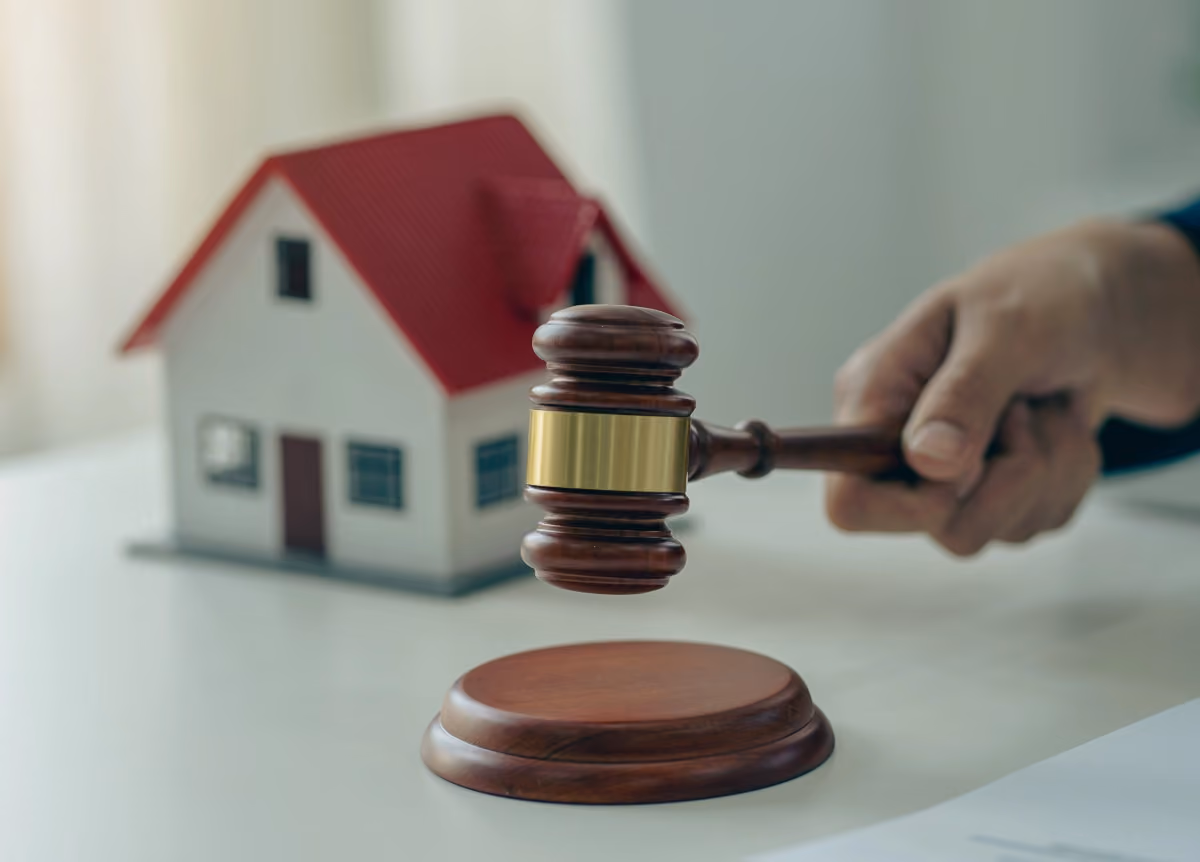 Model of house and a swinging gavel