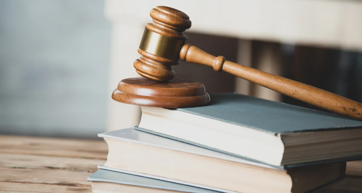 A judge's gavel resting on a stack of books