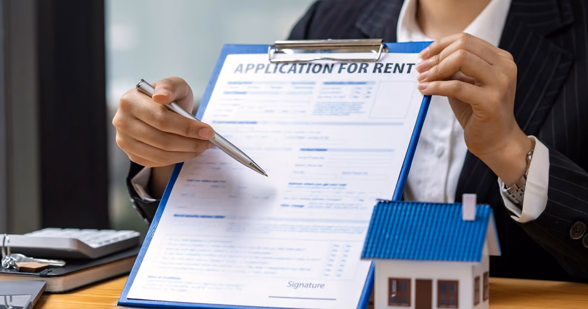 A person holding up a rental application form