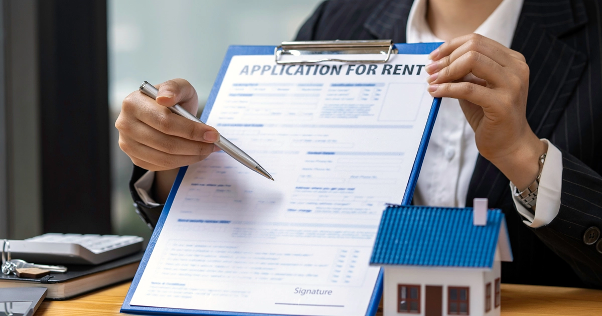 A person holding up a rental application form
