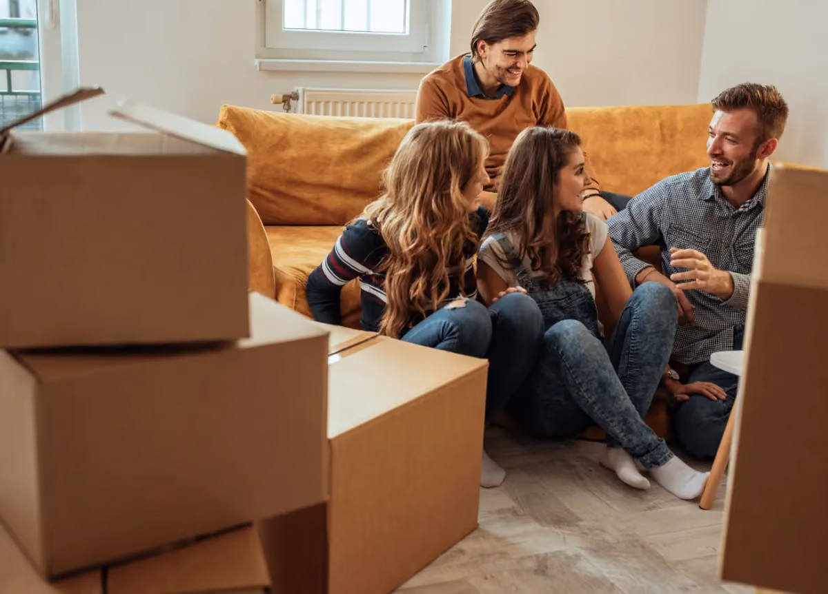 Roommates sitting around moving boxes