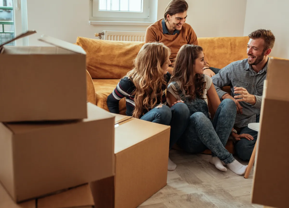 Roommates sitting around moving boxes
