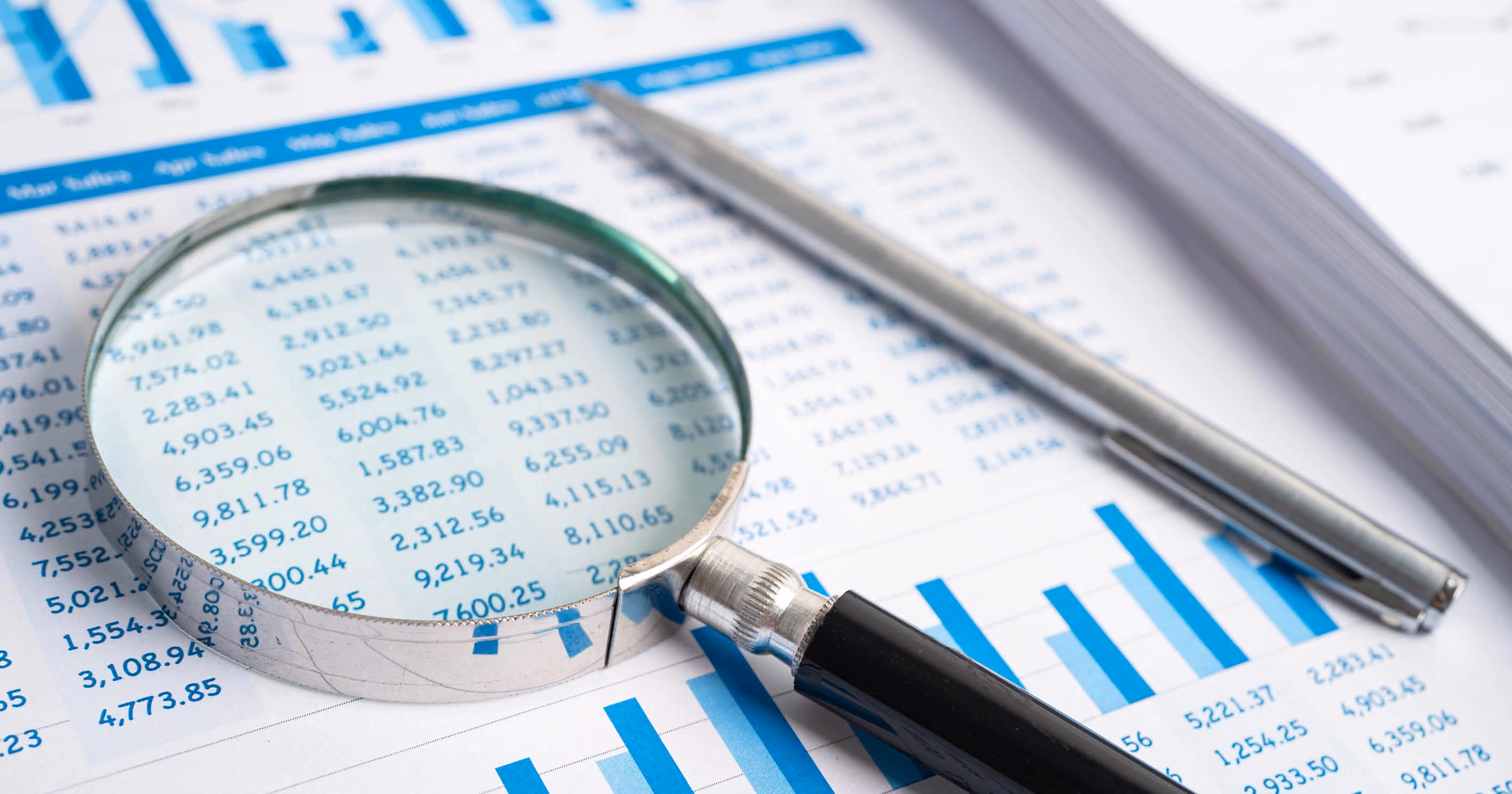 A magnifying glass on a table of figures