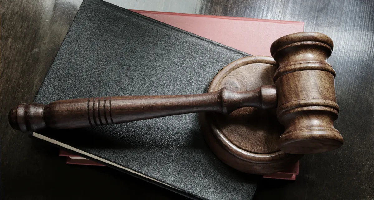 A gavel on top of a stack of books