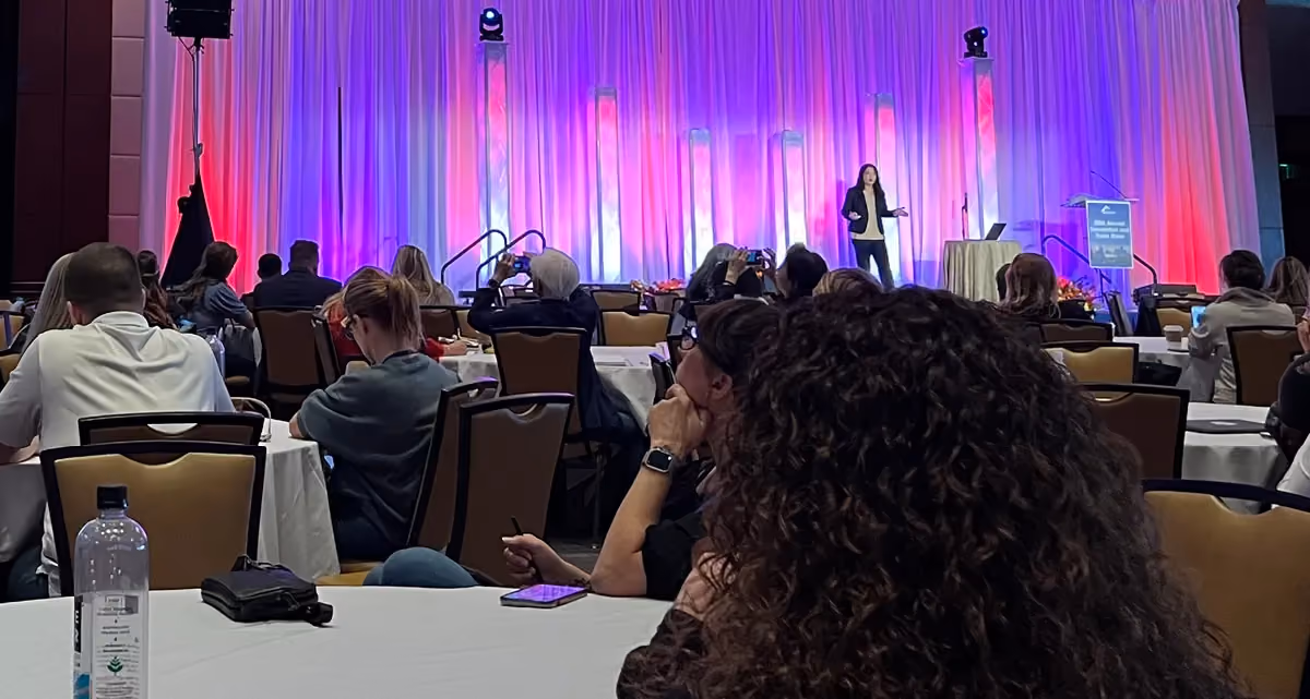 A group of people sitting and watching a speaker on stage at the 2023 NARPM Annual Convention