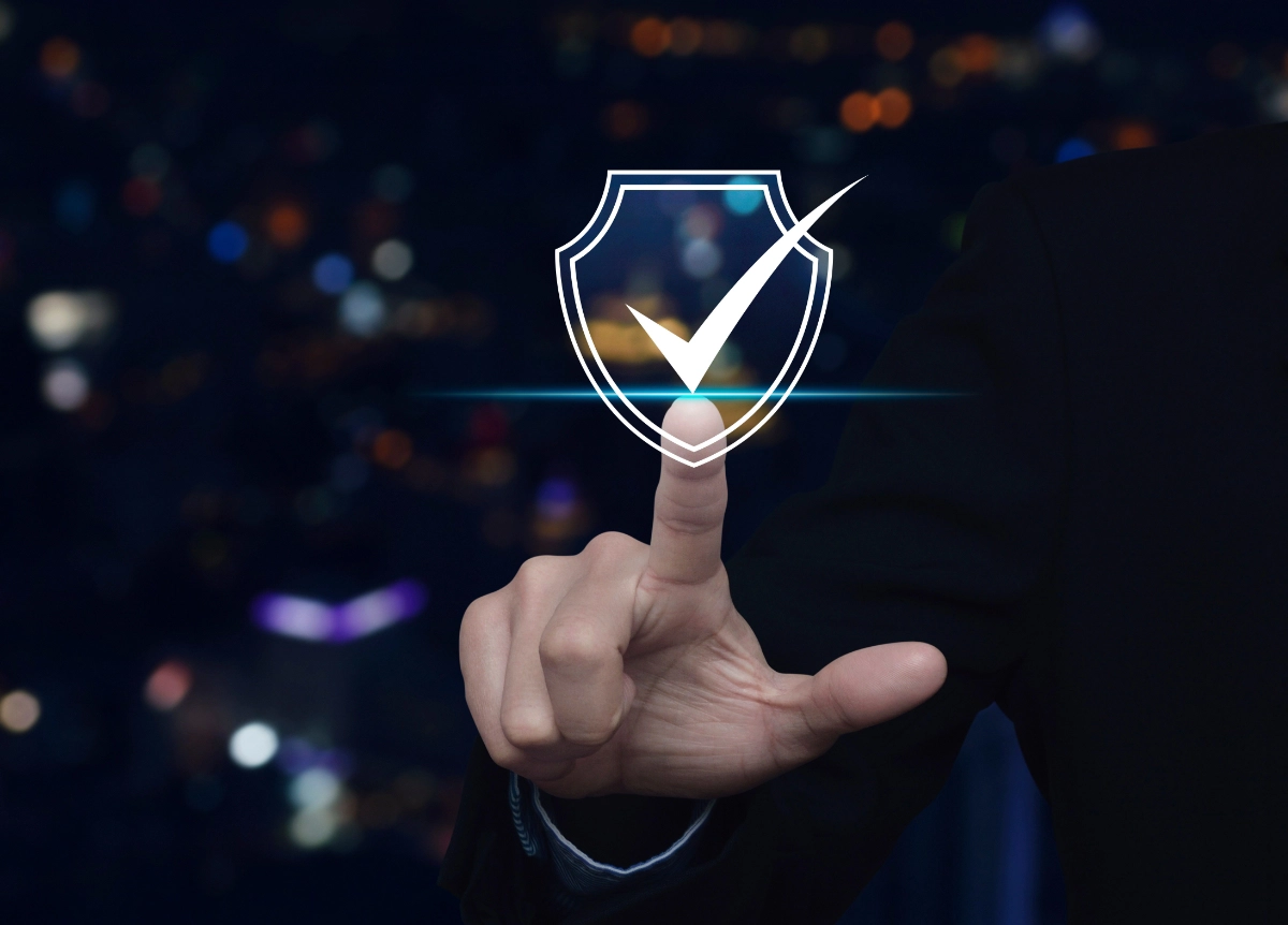 A person's hand pointing at an icon with a tick symbol