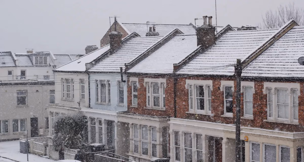 A row of terraced houses covered in snow