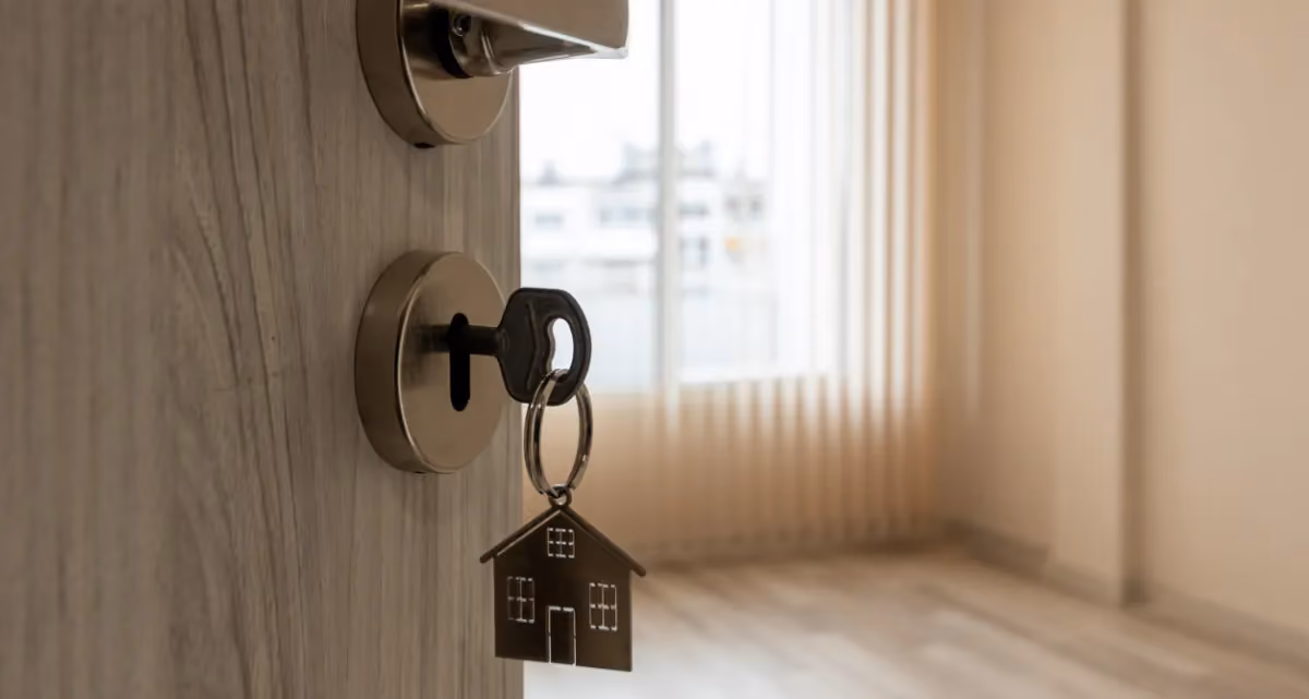 A key in the lock of an open door