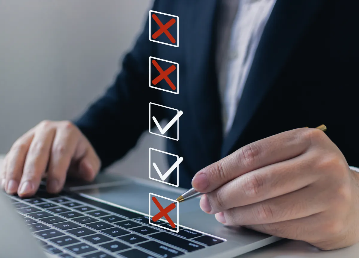 Man checks off or crosses out boxes on a document