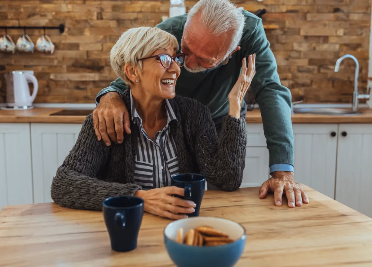 Senior couple drinks tea at table