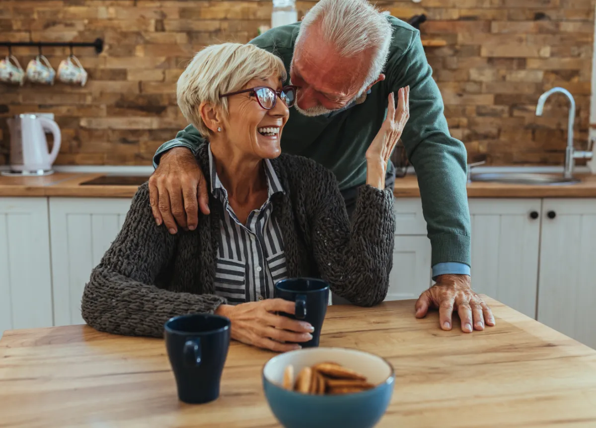 Senior couple drinks tea at table