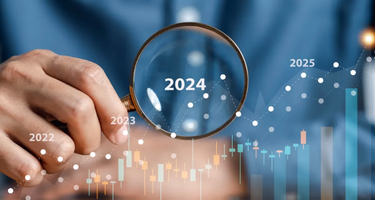 A person in a blue shirt with graphs and numbers superimposed over them, with 2024 in the centre