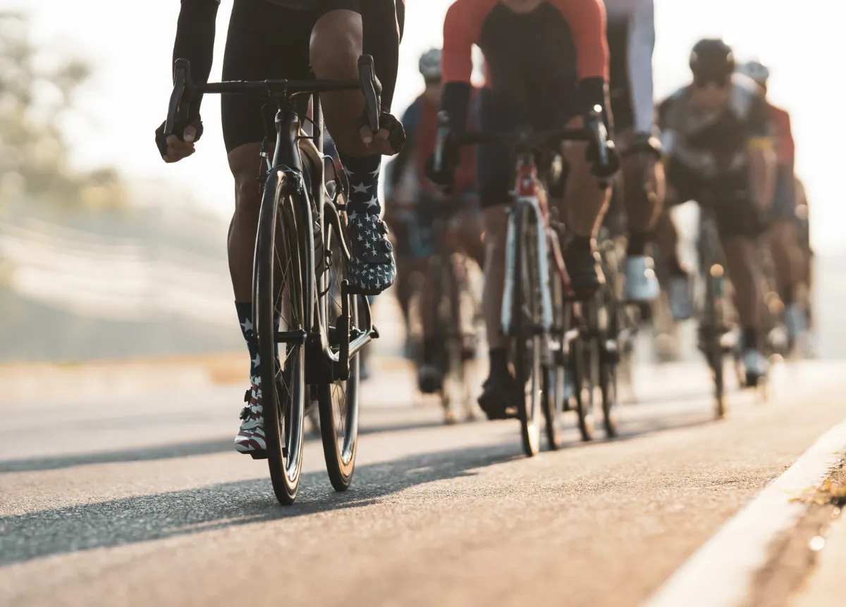 A group of cyclists on the road, seen from a low angle