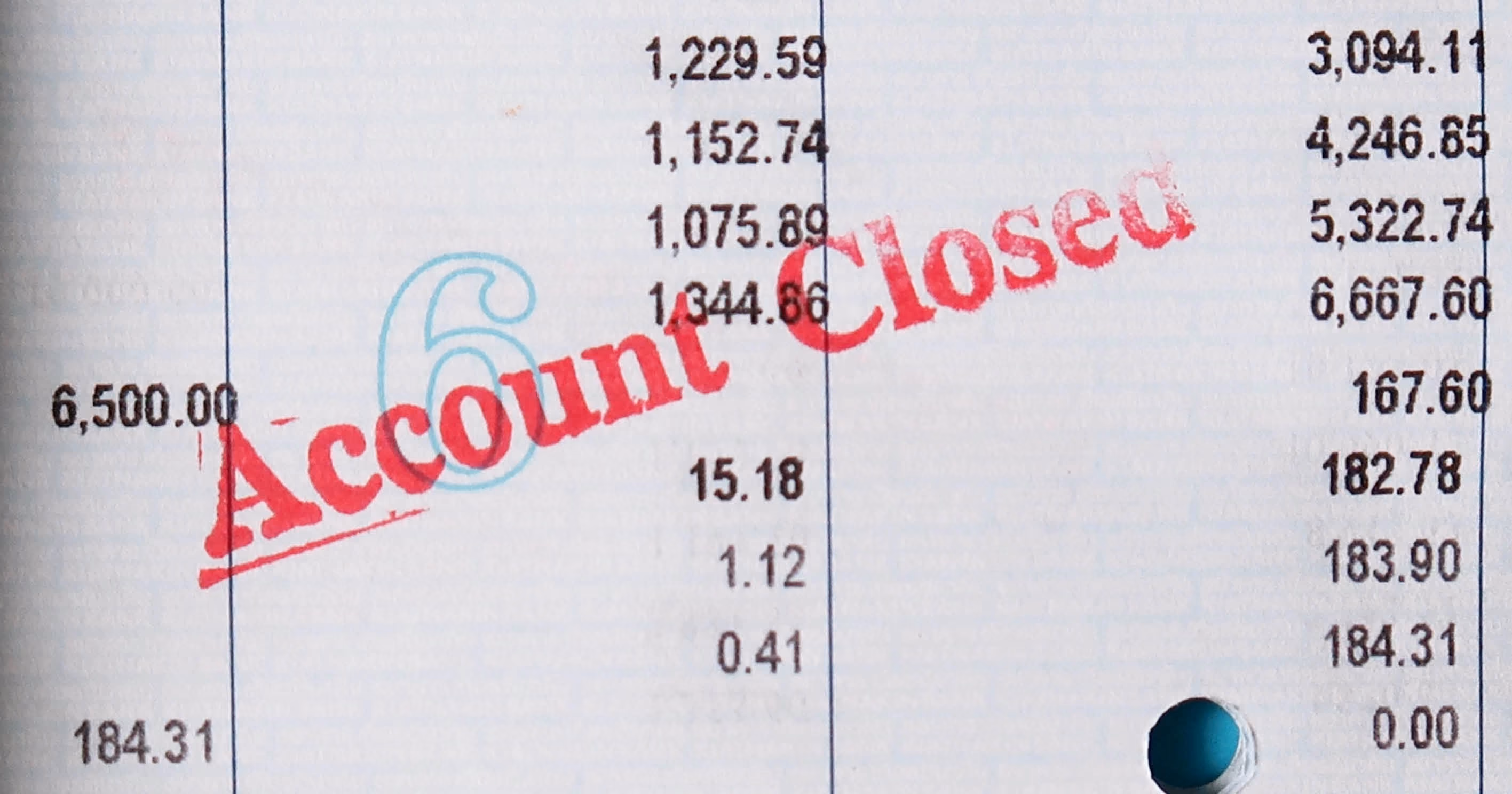 A bank statement with "account closed" stamped in red across it.