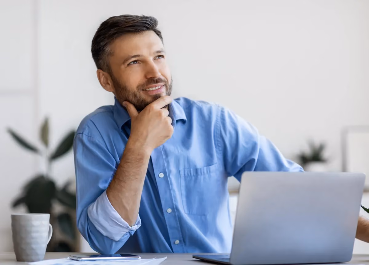 Man thoughtfully looking at computer screen