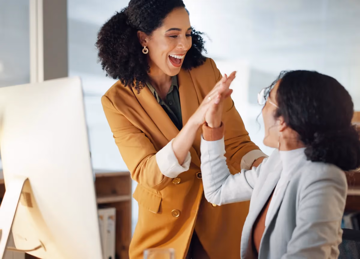 Businesswomen high-fiving